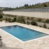 Piscina interrata con ampio piazzale vicino a un’infrastruttura autostradale